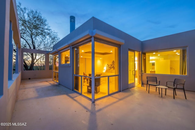 view of patio terrace at dusk