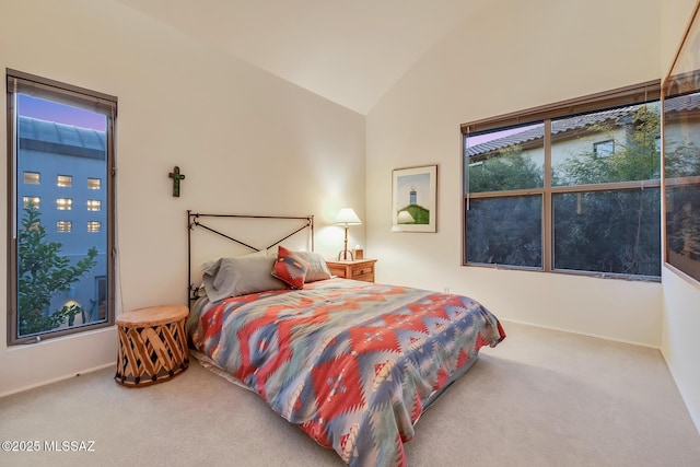 carpeted bedroom featuring lofted ceiling