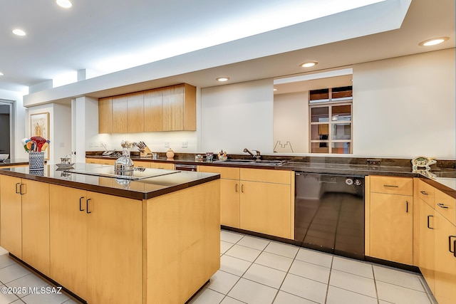 kitchen with light brown cabinetry, sink, and black appliances