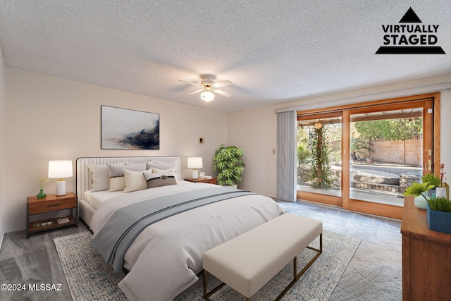 carpeted bedroom featuring access to exterior, ceiling fan, and a textured ceiling