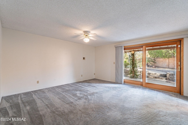 empty room with ceiling fan, carpet, and a textured ceiling