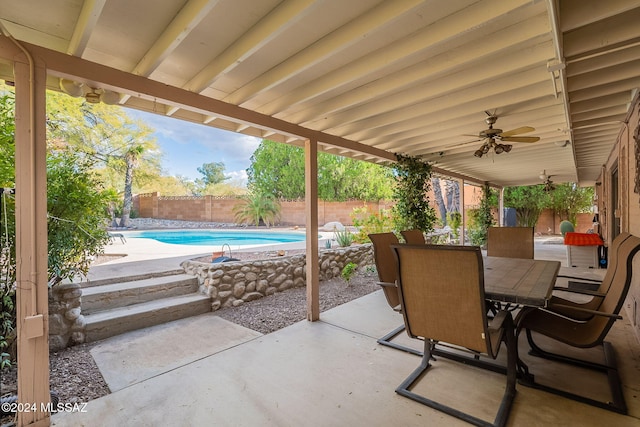 view of patio with ceiling fan and a fenced in pool