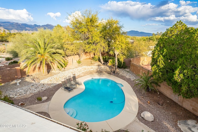 view of pool featuring a mountain view and a patio