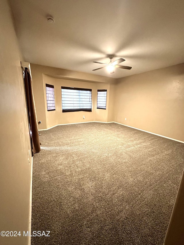 carpeted empty room with ceiling fan