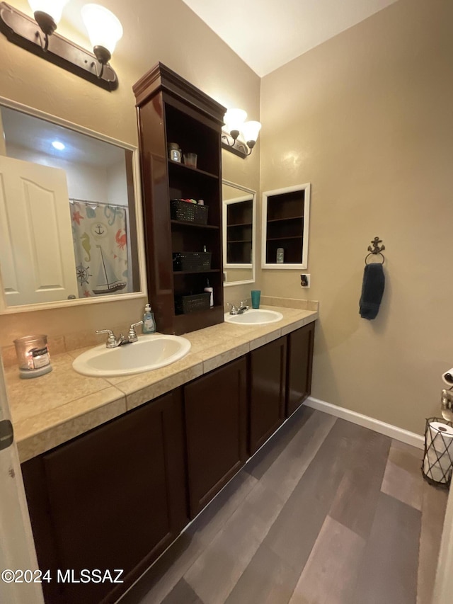 bathroom with hardwood / wood-style floors and vanity