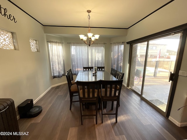 dining space featuring dark hardwood / wood-style flooring and an inviting chandelier