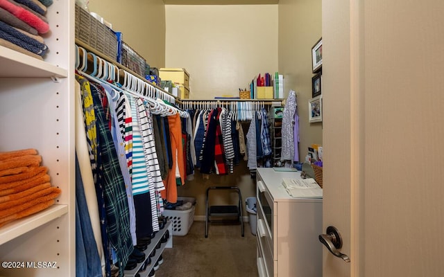 spacious closet featuring washer and clothes dryer and carpet floors