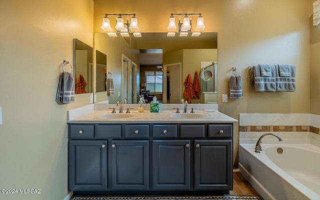 bathroom with hardwood / wood-style floors, vanity, and a tub to relax in