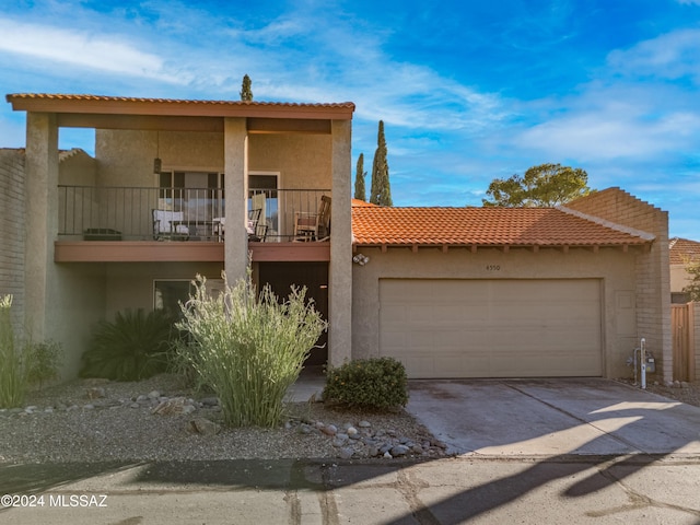 view of front of home featuring a garage and a balcony