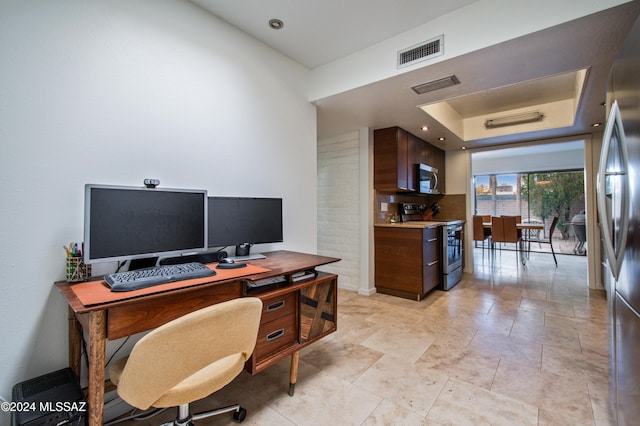 office area featuring a raised ceiling