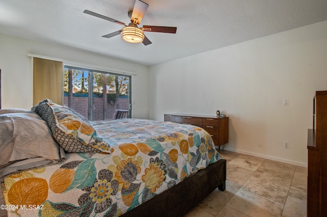 bedroom with ceiling fan, light tile patterned floors, and access to outside