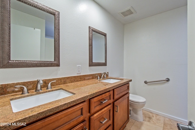 bathroom featuring tile patterned flooring, vanity, and toilet