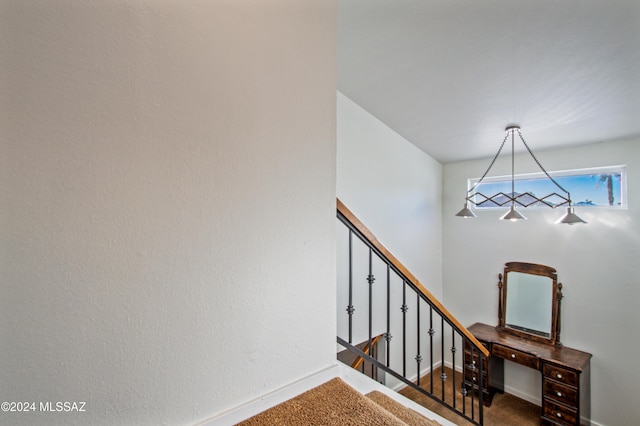 staircase featuring carpet flooring