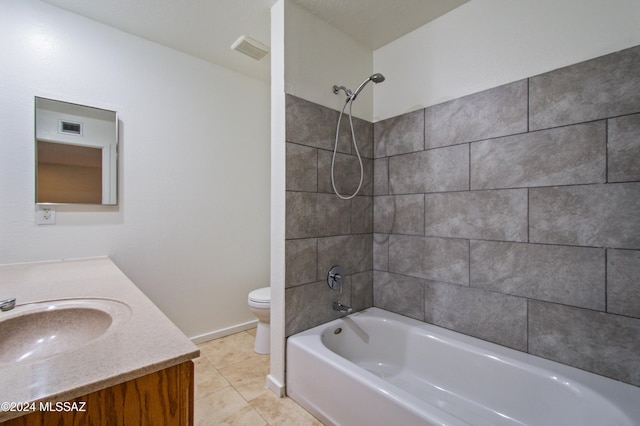 full bathroom featuring vanity, tiled shower / bath, tile patterned floors, and toilet