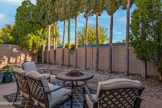 view of patio / terrace featuring an outdoor fire pit