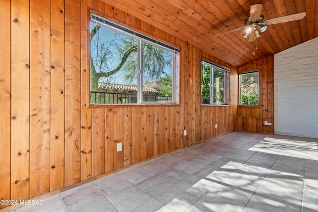 unfurnished sunroom featuring vaulted ceiling, ceiling fan, and wood ceiling