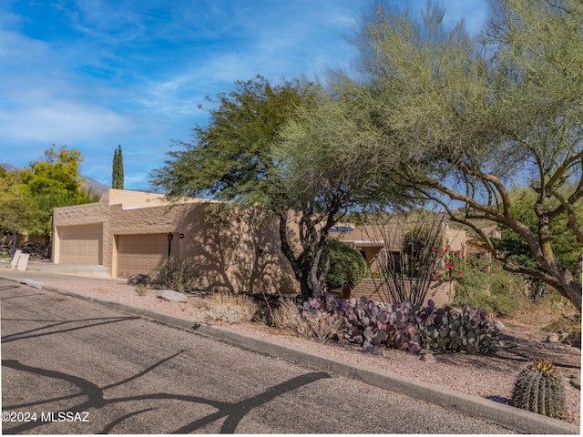 adobe home featuring a garage