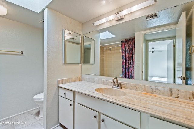 bathroom with tile patterned flooring, vanity, a shower with shower curtain, and toilet