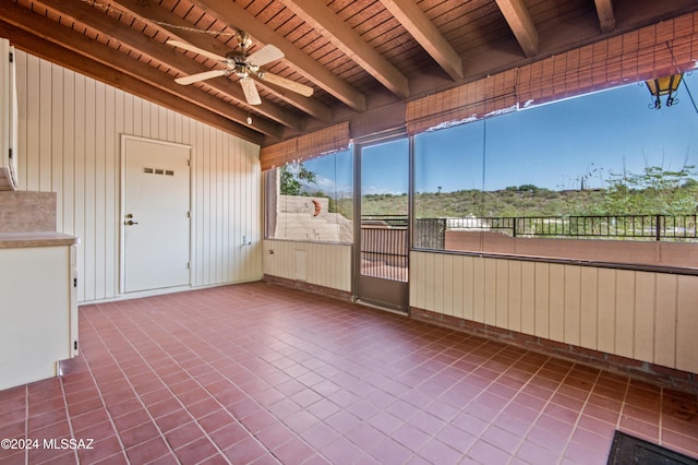 unfurnished sunroom featuring lofted ceiling with beams, ceiling fan, and wood ceiling