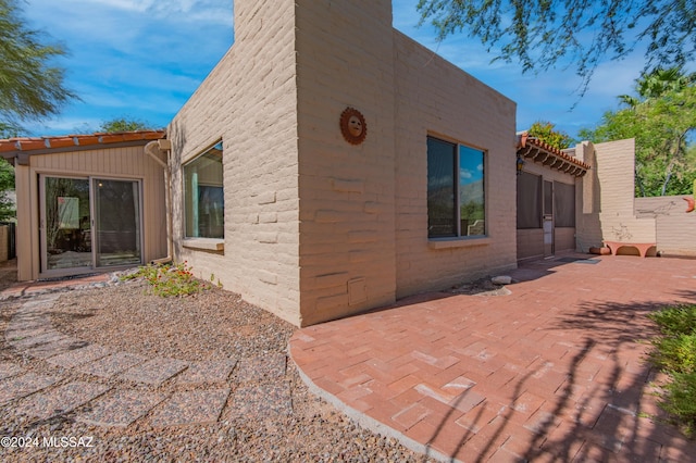 view of side of property with a patio area