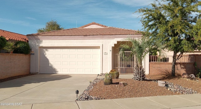 mediterranean / spanish-style house with a garage