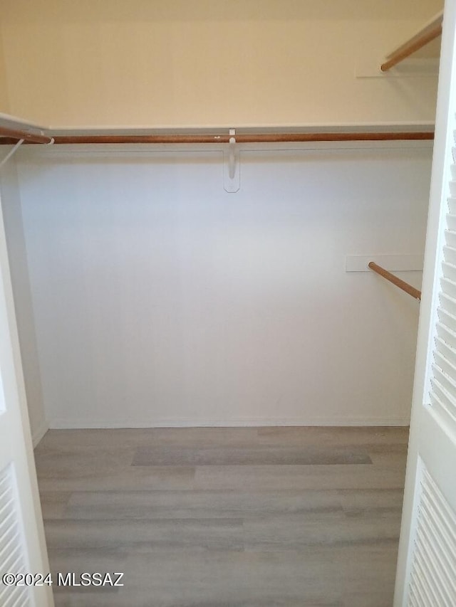 spacious closet featuring hardwood / wood-style flooring