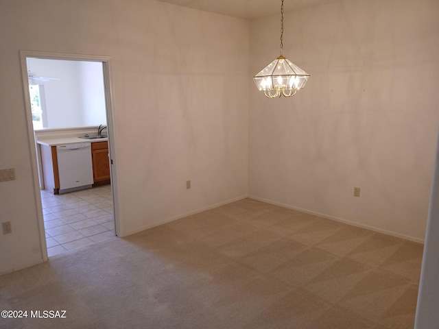 carpeted empty room featuring an inviting chandelier and sink