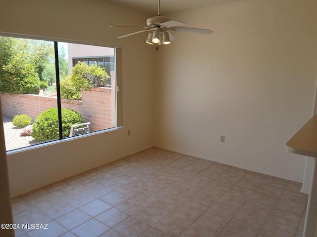 tiled empty room featuring ceiling fan