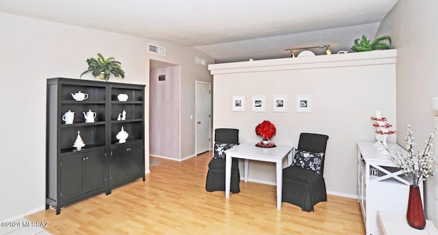 office with hardwood / wood-style floors and lofted ceiling