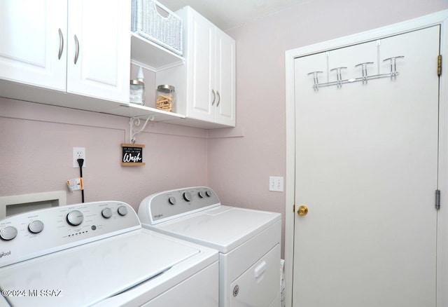 clothes washing area featuring cabinets and washing machine and dryer