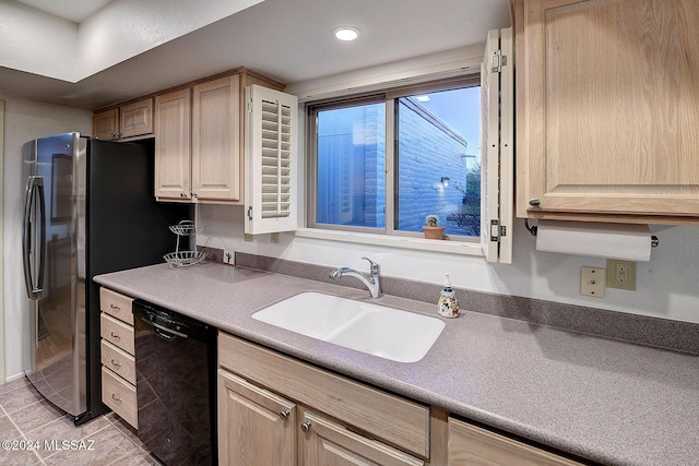 kitchen featuring light brown cabinetry, sink, dishwasher, and light tile patterned flooring