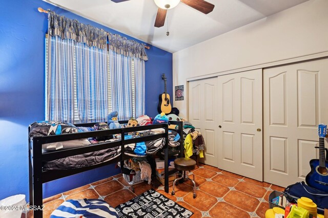 tiled bedroom featuring a closet and ceiling fan