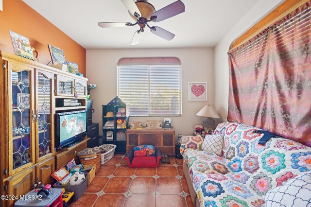 tiled living room featuring ceiling fan