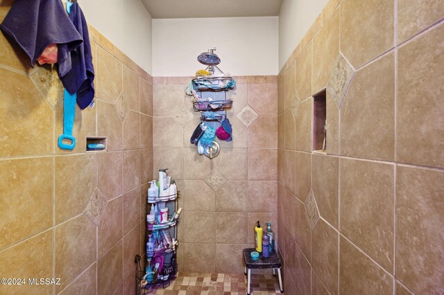 bathroom with tiled shower