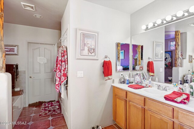 bathroom with tile patterned floors and vanity