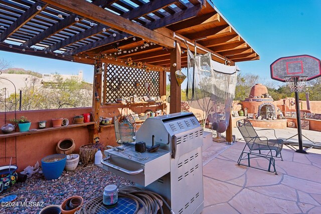 view of patio / terrace with a pergola and an outdoor fireplace