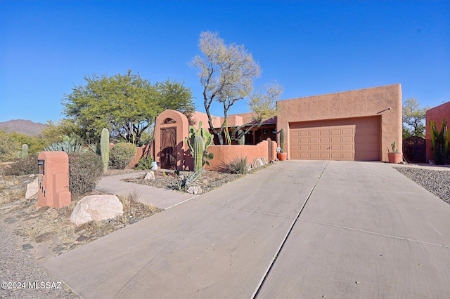 pueblo revival-style home featuring a mountain view and a garage