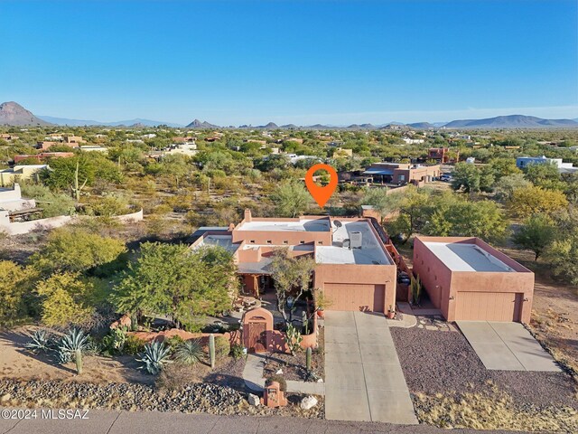 birds eye view of property with a mountain view