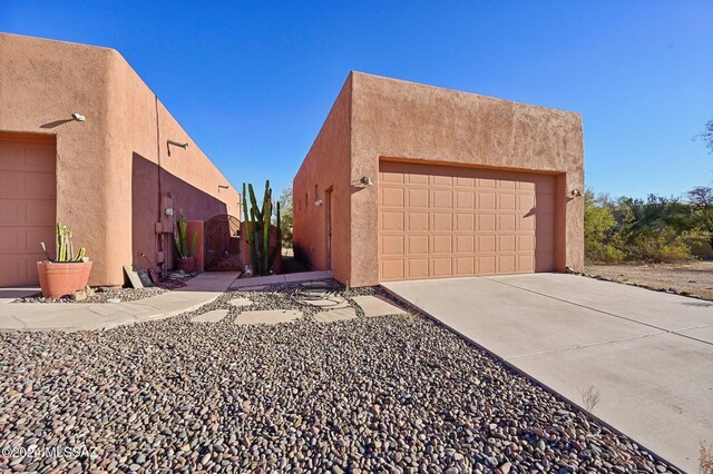 view of side of home featuring a garage