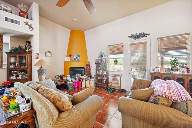 tiled living room with ceiling fan and a healthy amount of sunlight