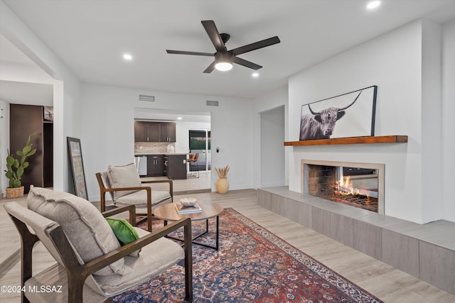 living room featuring ceiling fan and light wood-type flooring