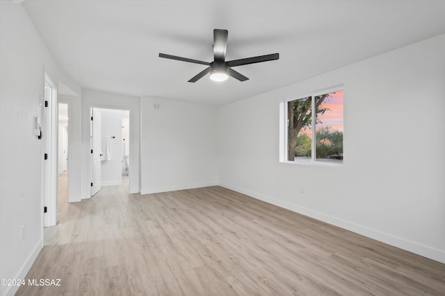 empty room featuring light hardwood / wood-style flooring and ceiling fan