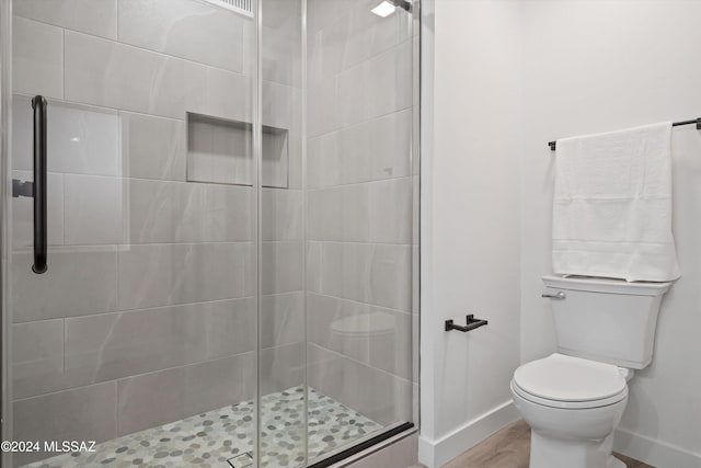 bathroom with toilet and walk in shower