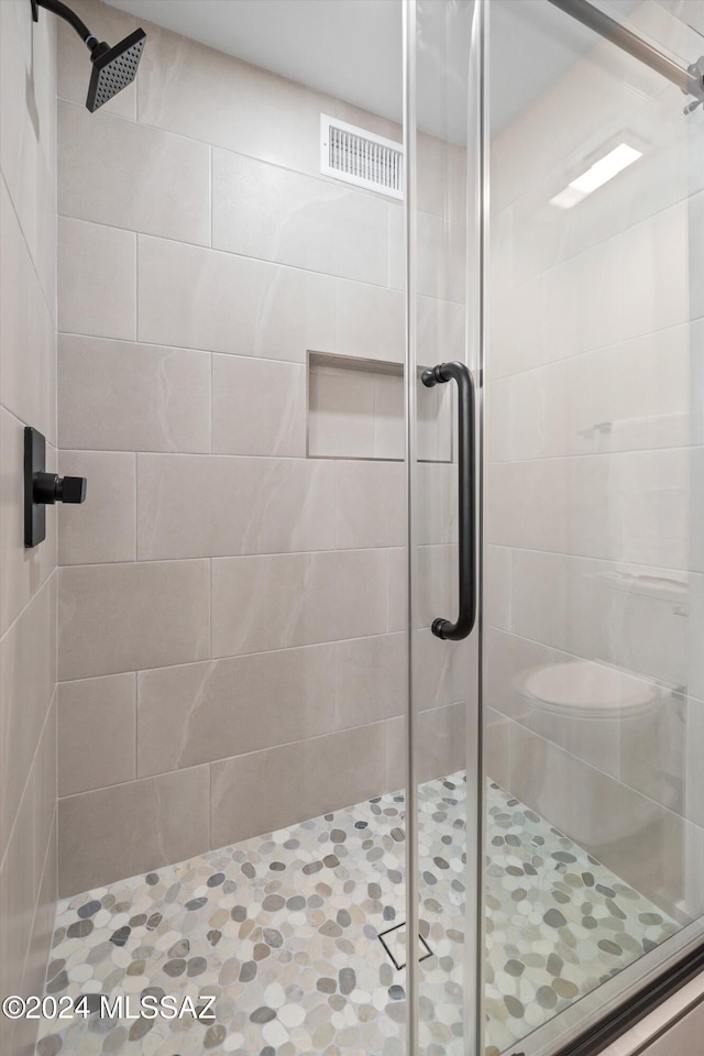 bathroom with toilet and walk in shower