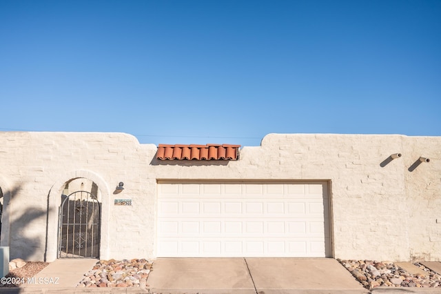 pueblo-style house with a garage