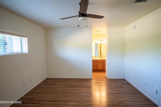 unfurnished room with dark hardwood / wood-style flooring and ceiling fan