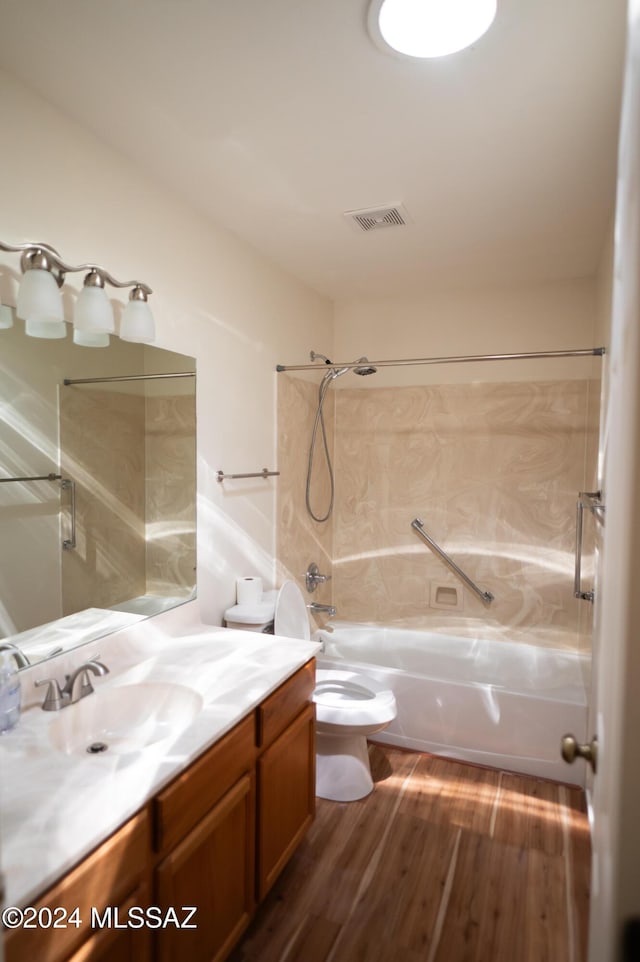 full bathroom with shower / bathing tub combination, vanity, wood-type flooring, and toilet