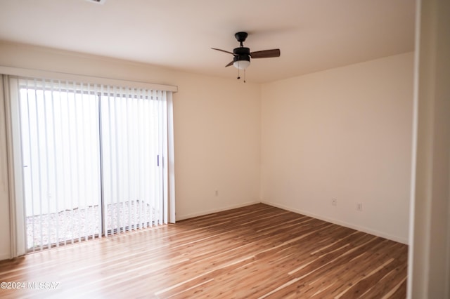 empty room featuring hardwood / wood-style flooring, plenty of natural light, and ceiling fan