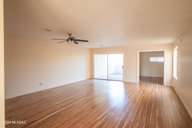 unfurnished room with ceiling fan and wood-type flooring