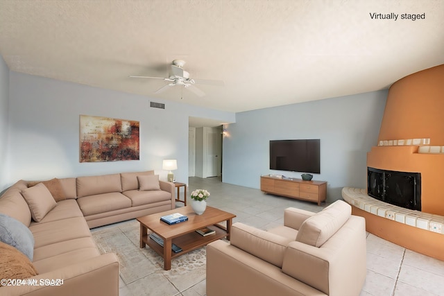 living room featuring light tile patterned floors and ceiling fan